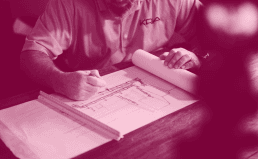 Image of a main drawing up blueprints.
